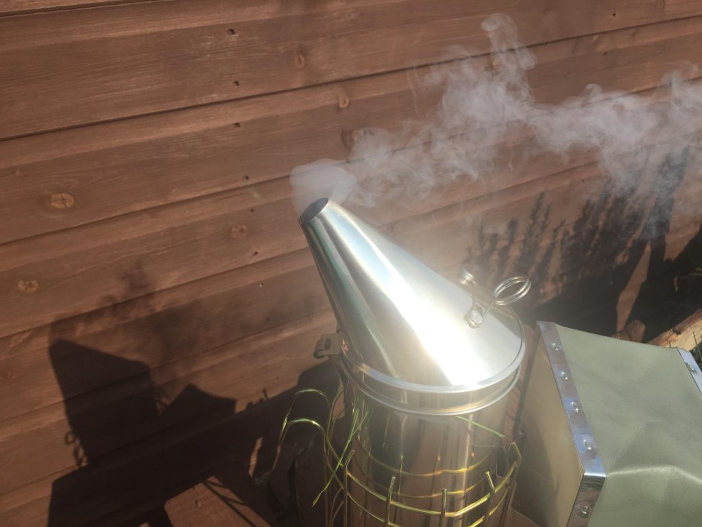 image showing a lit bee smoker